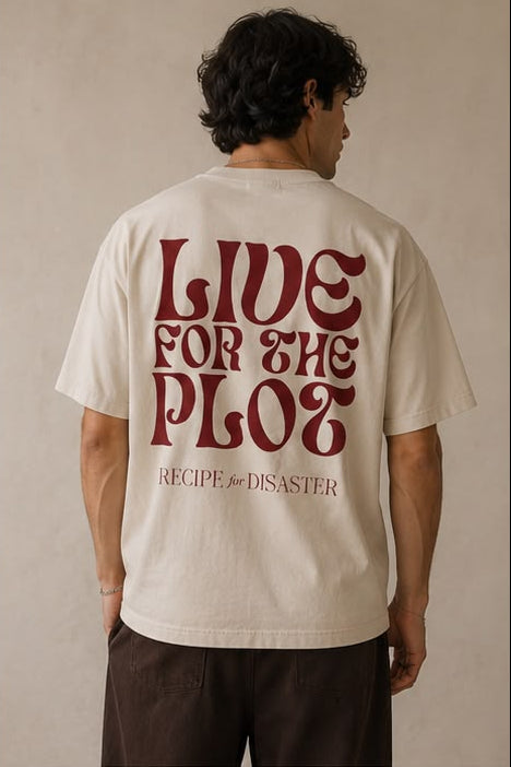 A man modelling a cream-colored short-sleeve t-shirt. The back view features a large red graphic reading 'LIVE FOR THE PLOT' and the Recipe for Disaster logo underneath